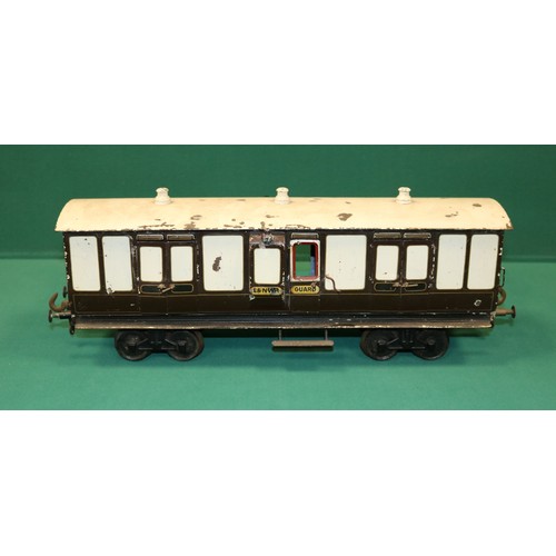 223 - A rare Bing Gauge 3 L&NWR bogie Guards Van. 45cm, buffer to buffer, in lined dark brown and white li... 