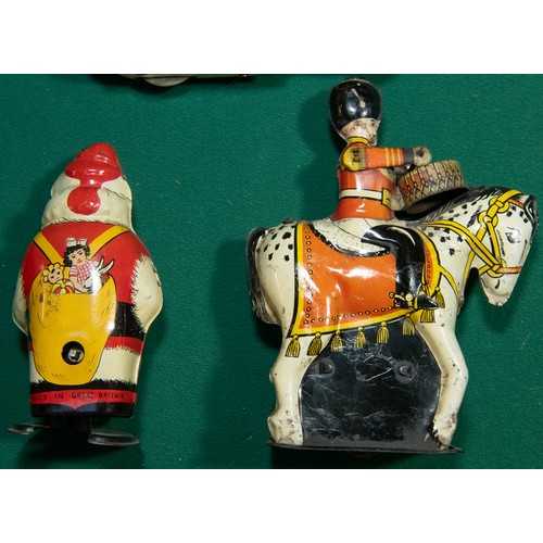 248 - 4 vintage Clockwork tinplate toys. Wells Brimtoy Santa Clause with walking action, Drummer on horseb... 