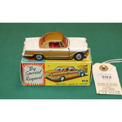 392 - Corgi Toys Triumph Herald Coupe (231). In white and metallic gold with red interior, smooth wheels w... 