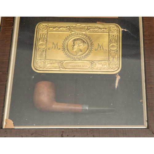 14 - A WWI Princess Mary gift tin, with cards and pipe in a glazed frame; Army book 136 marked to A.C. Su... 