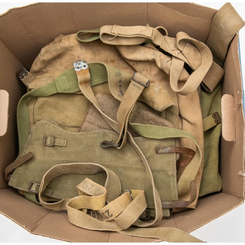 153 - A large quantity of WWII webbing equipment, small packs, large packs, officers haversacks, straps, g... 