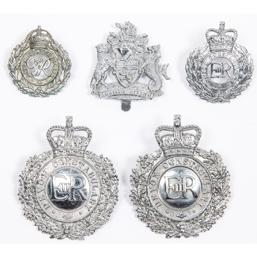 16 - Four obsolete Devon Constabulary badges: chrome plated ERII wreath pattern helmet badge; another sim... 