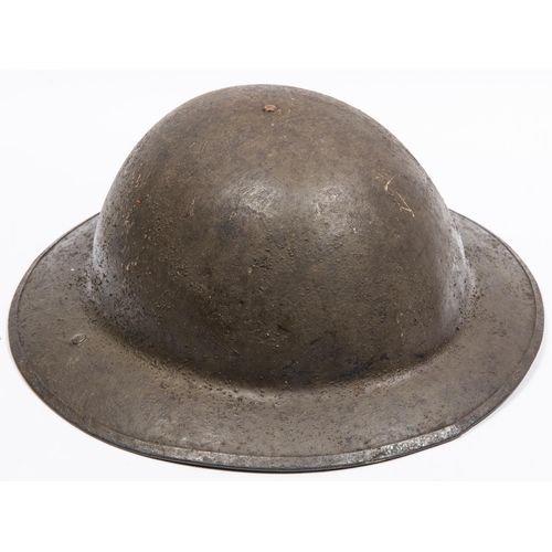 305 - A WWI British Brodies Pattern steel helmet, with turned over rim, the underside of the brim stamped ... 