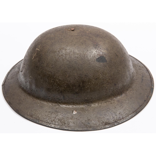 305 - A WWI British Brodies Pattern steel helmet, with turned over rim, the underside of the brim stamped ... 