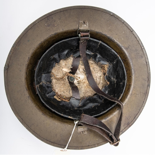 305 - A WWI British Brodies Pattern steel helmet, with turned over rim, the underside of the brim stamped ... 