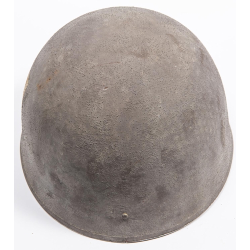 306 - A WWII British Airborne steel helmet, with webbing chinstrap, dated 1942, the skull with rough finis... 