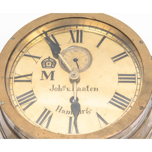 67 - An Imperial German ship's bulkhead clock, the brass face having black Roman numerals, maker's name 