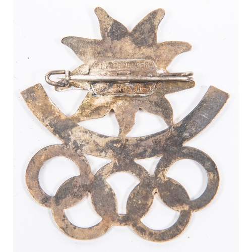 89 - A Third Reich pin back badge for the 1936 Winter Olympics, in white metal and enamel, inscribed 