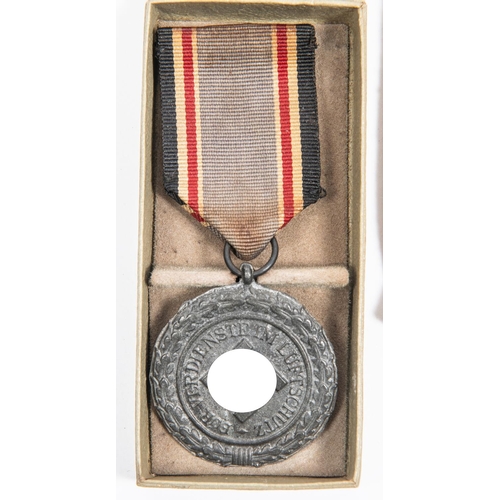 96 - A Third Reich Luftschutz Decoration 2nd class, with ribbon, and pin, in its box with printed lid; Mo... 