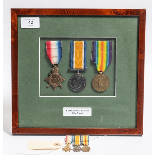 42 - Three: 1914-15 star. BWM, Victory, nicely framed with named title (S-2184 Private J Churchill Rifle ... 