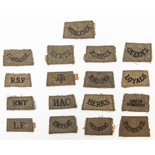 244 - 17 British WWII slip on shoulder titles. £80-100