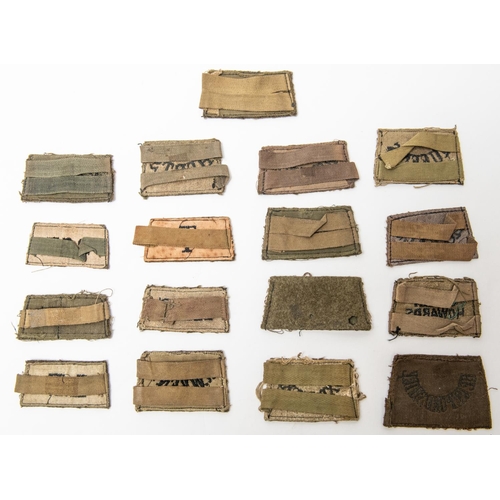 244 - 17 British WWII slip on shoulder titles. £80-100