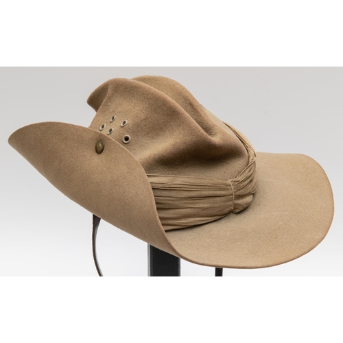 312 - A WWII British khaki slouch hat, khaki linen puggaree, leather chinstrap and lining, dated 1943. GC ... 