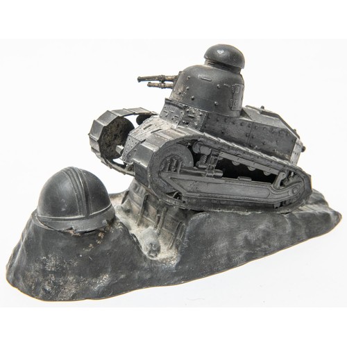 19 - A spelter desk inkwell in the form of a French light tank ascending a rocky slope, with revolving tu... 