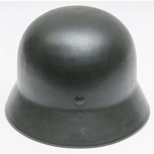 102 - A Third Reich M35 steel helmet, repainted at an early date with grey paint, complete with lining and... 