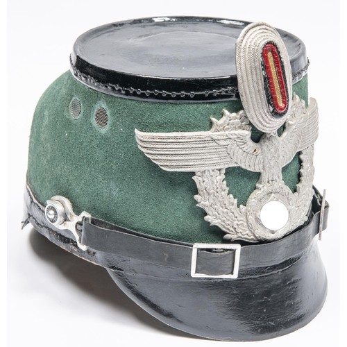 110 - A German Police shako, with Third Reich aluminium eagle badge and cockade. GC £300-350