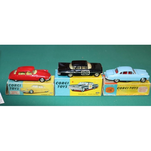 299 - 3 Corgi models. Citroen DS19 (210S), in red with yellow interior. Chevrolet 'State Patrol' (223), in... 