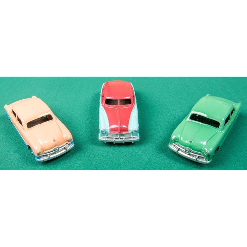 316 - 3 Dinky Toys American cars. A Ford Sedan, a low-line example in pink and blue with blue wheels. Anot... 