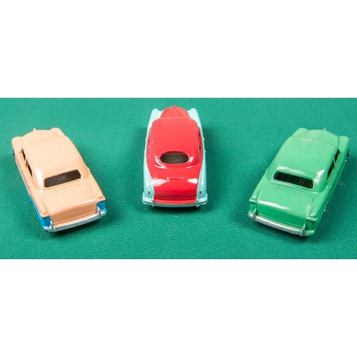 316 - 3 Dinky Toys American cars. A Ford Sedan, a low-line example in pink and blue with blue wheels. Anot... 