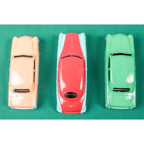 316 - 3 Dinky Toys American cars. A Ford Sedan, a low-line example in pink and blue with blue wheels. Anot... 