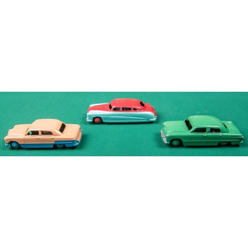 316 - 3 Dinky Toys American cars. A Ford Sedan, a low-line example in pink and blue with blue wheels. Anot... 