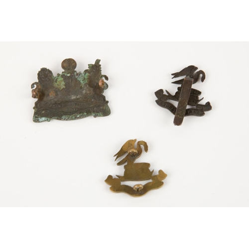 156 - Liverpool Pals officer's very pale bronze cap badge, with two lugs; another, OR's dark bronze with s... 