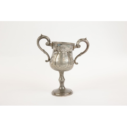 65 - A pewter 2 handled prize footed cup, embossed with flowers and scrolls, a panel on one side engraved... 