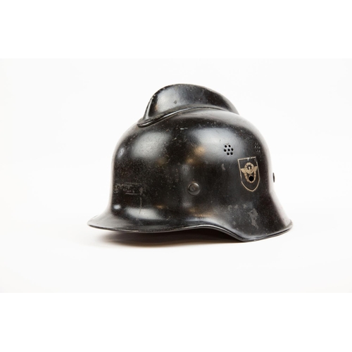 87 - A Third Reich Fire Police steel helmet, black skull with vents and crest and with Police decals, lea... 