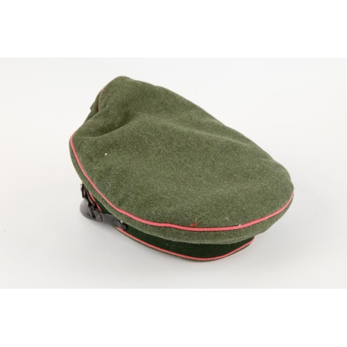 88 - A Third Reich Panzer officer's peaked cap, with fibre peak, metal insignia, and pink piping. GC, the... 