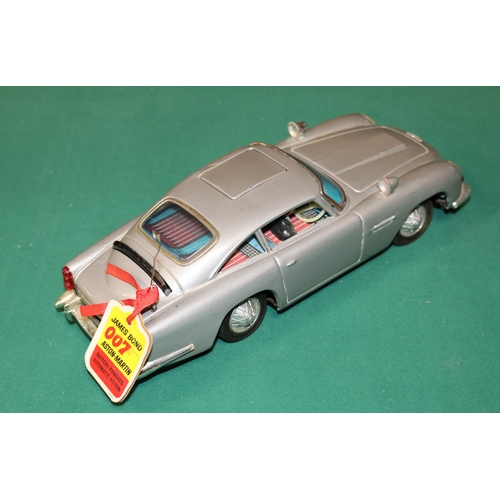 101 - James Bond tinplate Aston Martin toy by Gilbert of  America. Battery operated mechanism operates fla... 