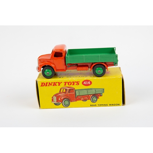 338 - 2 Dinky Toys. Dodge Rear Tipping Wagon (414). An example with orange cab and chassis, with mid green... 