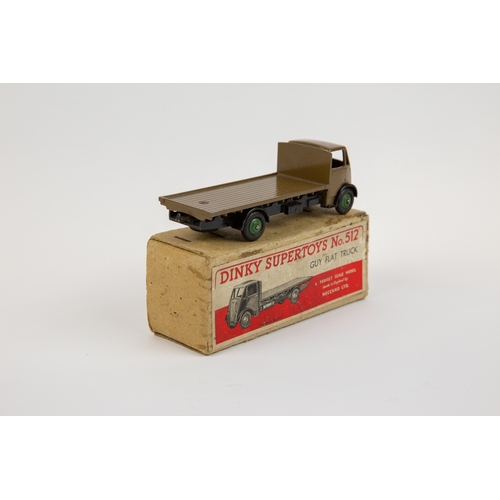 392 - Dinky Supertoys Guy Flat Truck (512). A scarce very early example in khaki cab and flatbed with blac... 