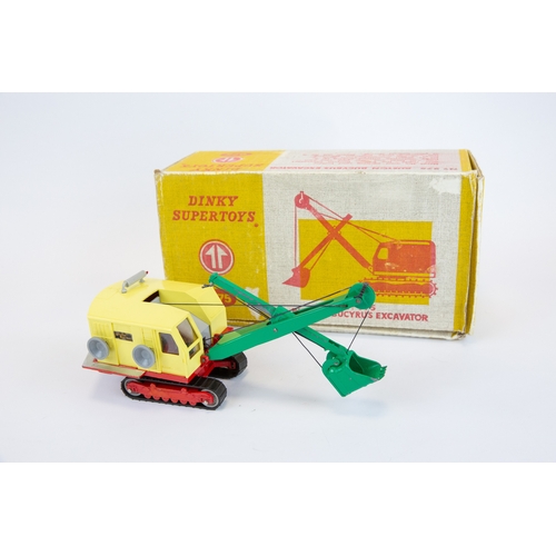 397 - Dinky Supertoys Ruston Bucyrus Excavator (975). Pale yellow plastic body, green jib and bucket, red ... 