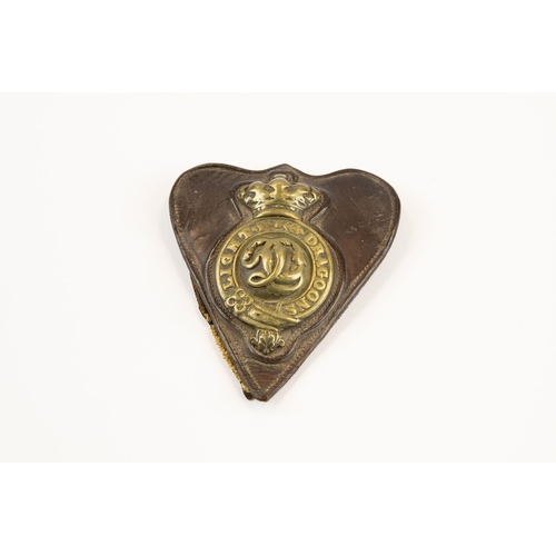 251 - A Victorian Light Dragoons brass martingale badge, on its heart shaped leather backing containing a ... 