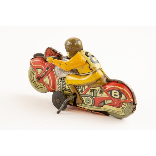 266 - Tinplate TN Japan clockwork powered Racing/stunt Motorcycle. Length 13cm, racing number 8. In red  w... 