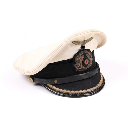 64 - A Third Reich naval officer's peaked SD cap, bullion insignia and peak embroidery, white top, lining... 