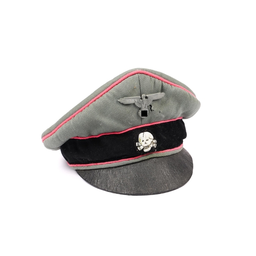 66 - A Third Reich SS type cap, field grey with pink piping, metal eagle badge, embroidered skull. GC £30... 