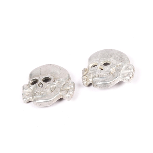 72 - Two Third Reich SS aluminium cap skulls, marked with RZM and maker's code. GC (each with one fixing ... 