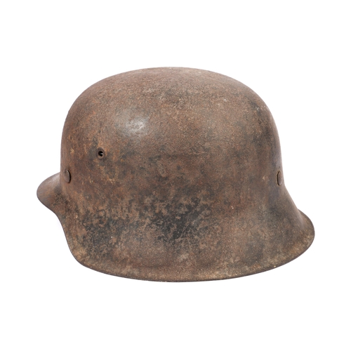 75 - A Third Reich M1943 SS raw edge steel helmet, retains 1 SS decal and traces of black finish, sound c... 