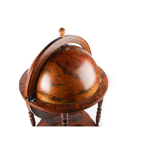 370 - A modern terrestrial globe in the antique style, on a wooden stand decorated with the signs of the Z... 