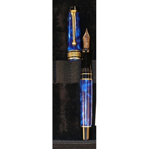 433 - An Aurora Optima Cobalt blue & gold Fountain Pen. With a 14k gold nib. Greek Key design around centr... 