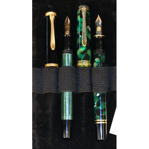 439 - 2 Pelikan Fountain Pens. With gold nibs. One variegated green and black. The other green and black s... 