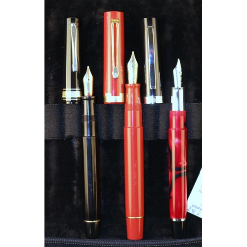 440 - 3 Omas Fountain Pens. An Omas with silver nib, variegated red and black, with silver detailing and b... 