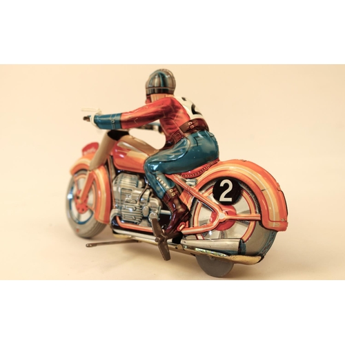 635 - A Technofix GE255 tinplate clockwork racing motorcycle. Brightly coloured in orange with litho detai... 