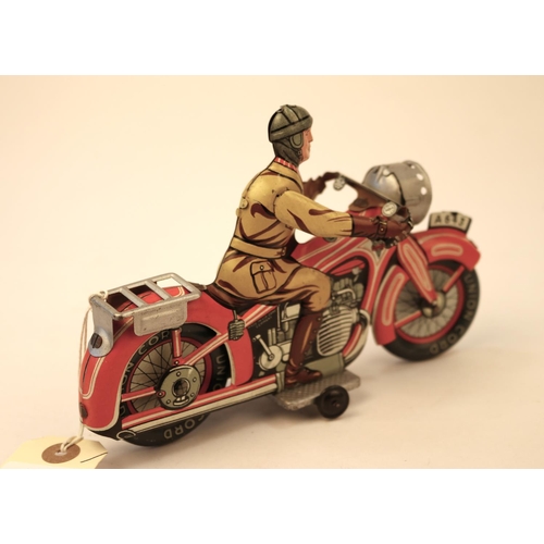 638 - A rare Arnold A643 tinplate clockwork touring motorcycle. In red and white with litho detailing, rid... 