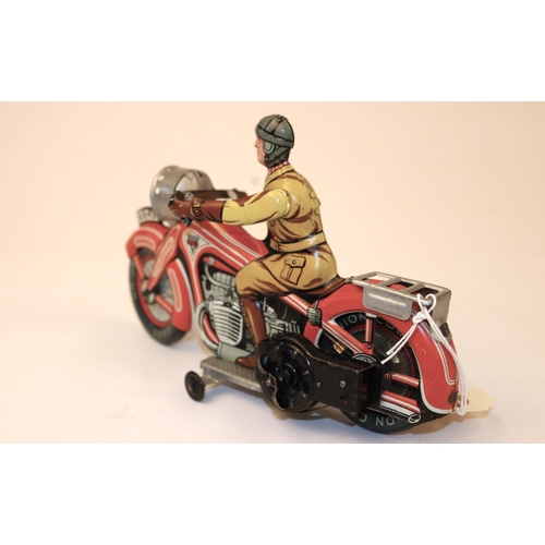 638 - A rare Arnold A643 tinplate clockwork touring motorcycle. In red and white with litho detailing, rid... 