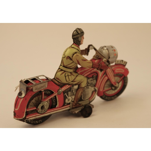 639 - A rare Arnold A643 tinplate clockwork touring motorcycle. In red and white with litho detailing, rid... 