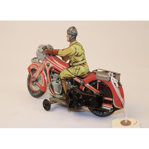 639 - A rare Arnold A643 tinplate clockwork touring motorcycle. In red and white with litho detailing, rid... 