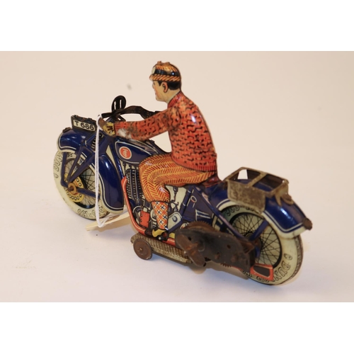 640 - A rare Tipp & Co tinplate clockwork motorcycle T686. Bike in dark blue with Litho detail, with civil... 