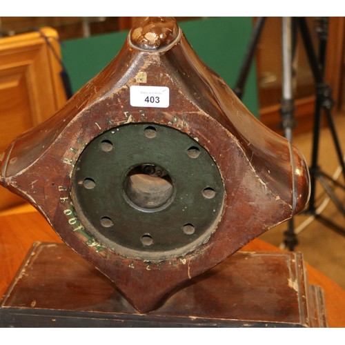 403 - A mantle clock set in a mahogany propeller boss, marked 